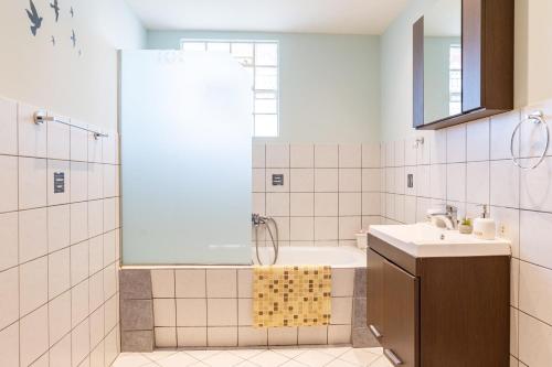 a bathroom with a shower and a tub and a sink at Kos Dream Family Stay in Kos in Zipárion