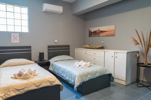 a bedroom with two beds with towels on them at Kos Dream Family Stay in Kos in Zipárion
