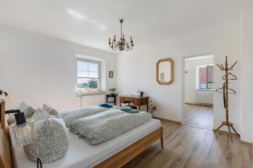 a white bedroom with a bed and a mirror at Villa Romantika in Ichenhausen