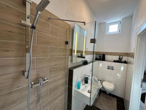 a bathroom with a shower and a toilet and a sink at Dreams Unterkunft in Koetz 