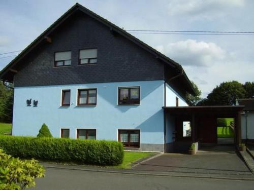 a large blue house with a black roof at Apartment Orpington by Interhome in Dreisbach