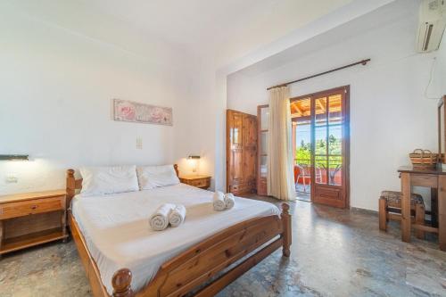 a bedroom with a bed with two towels on it at Arianna Studio Ground Floor 6 in Paleokastritsa