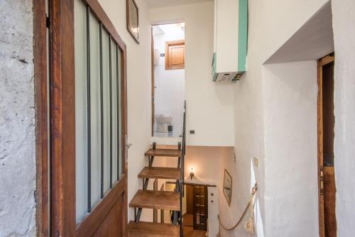 a hallway with a door and stairs in a house at Casa Francesca in Montalcino