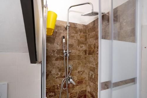 a shower in a bathroom with a glass door at Hemingway's Shelter in La Spezia