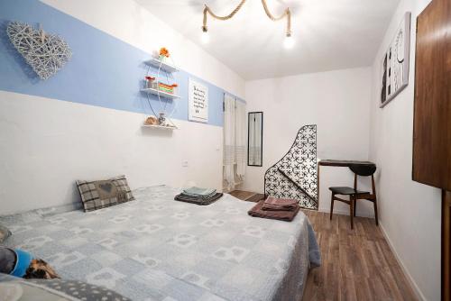 a small room with a bed and a chair at Hemingway's Shelter in La Spezia