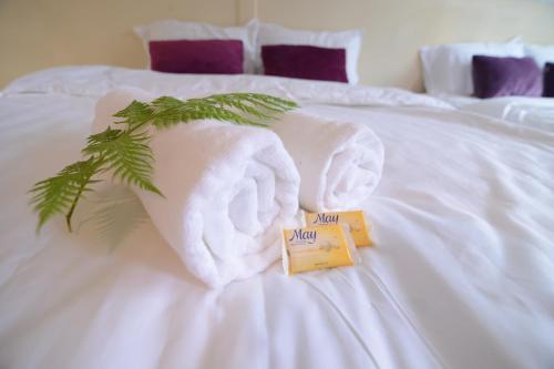 a towel animal on a bed with a book at T Paradise in Kundasang