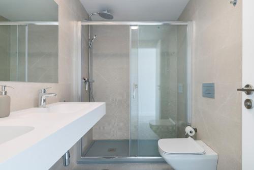 a bathroom with a shower and a toilet and a sink at Central Apartment with a view in Mijas