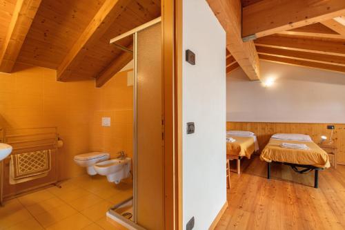 a bathroom with two toilets and a sink at Agriturismo Soleil Levant Torgnon in Torgnon