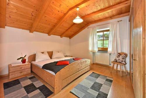 a bedroom with a bed and a wooden ceiling at Gatterpunerhof in Vols am Schlern