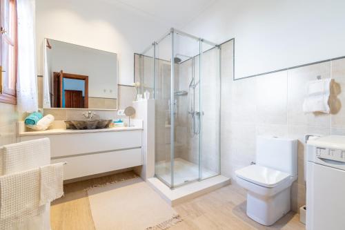 a bathroom with a shower and a toilet and a sink at Son Amanada in Santa Margalida