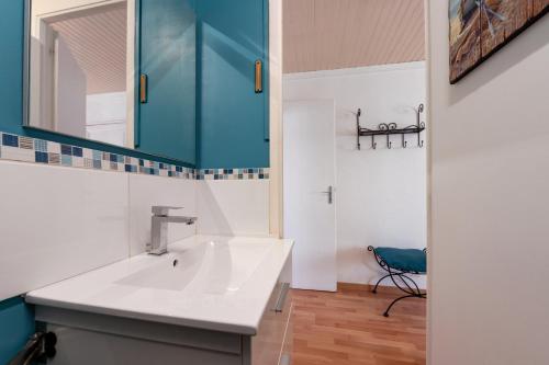 a bathroom with a sink and a mirror at Kervalou in Sainte Anne d'Auray