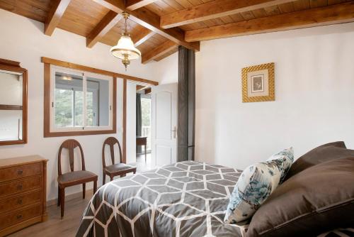 a bedroom with a bed and a table and chairs at La Bodega de Julián in Tegueste