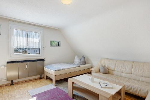 a living room with a couch and a table at Ferienwohnung Honacker in Steißlingen