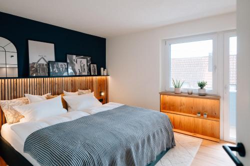 a bedroom with a large bed and a large window at Fewo Tauberblick in Röttingen