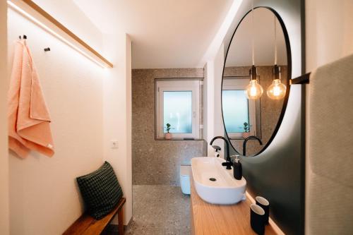 a bathroom with a sink and a mirror at Fewo Tauberblick in Röttingen