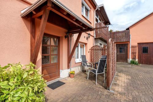 a patio with two chairs under awning on a house at Ferienwohnung Ahrens in Ehrenberg