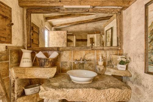 a bathroom with a sink and a large mirror at Madara in Monóvar
