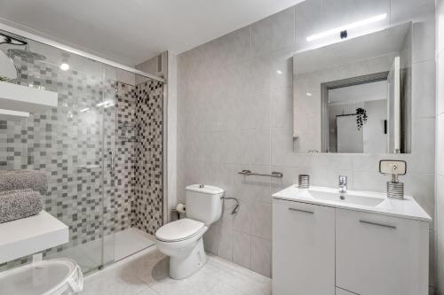 a bathroom with a toilet and a sink and a shower at Apartamento Retama in Adeje