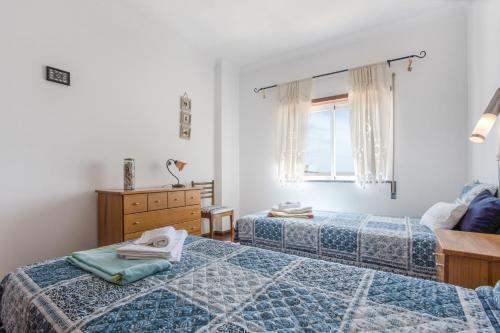 a bedroom with two beds and a window at Your Secret in Lagos in Lagos