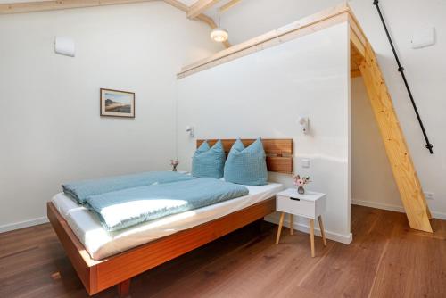 a bedroom with a large bed with blue pillows at Ferienwohnung Marie in Egling