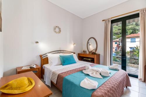 a hotel room with two beds and a window at Nikoleta Apartment A in Nikiana