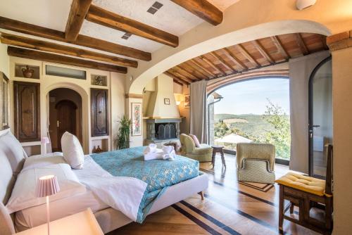 a bedroom with a large bed and a large window at Podere Erbolino in Gaiole in Chianti
