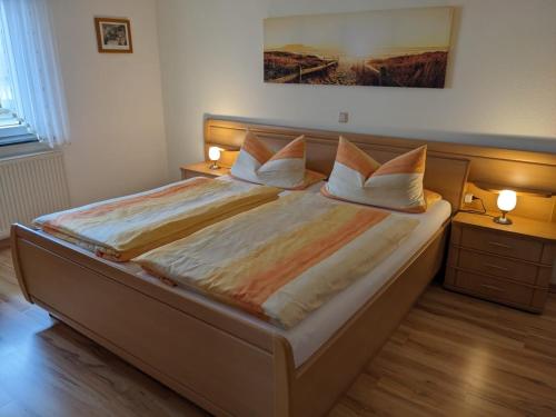 a bedroom with a large bed with two lamps on it at Appartement Karolina in Bad Soden-Salmünster