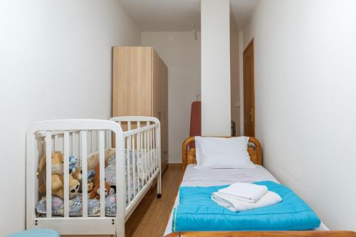 a small room with a crib and teddy bears at Moraki Apartment 1 Andros in Korthi
