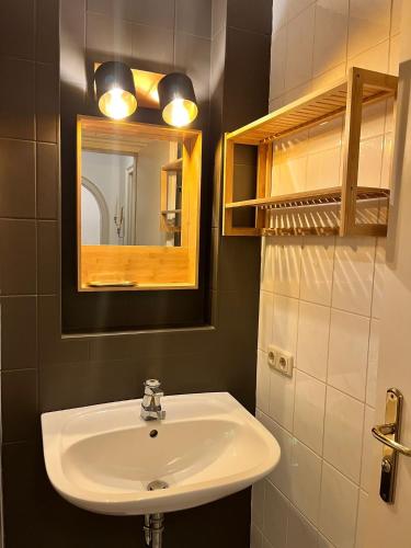 a bathroom with a sink and a mirror at Ferienwohnung im Burghotel in Aschau im Chiemgau
