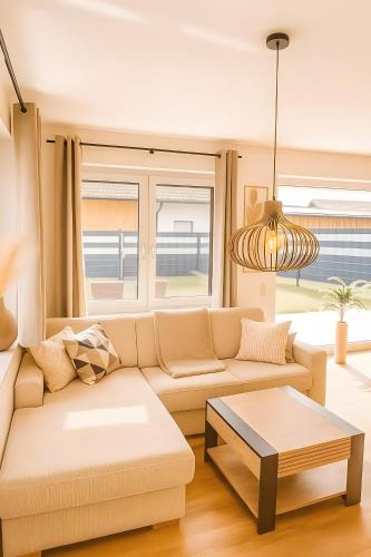a living room with a couch and a table at Ferienwohnung Pruggernglück in Pruggern