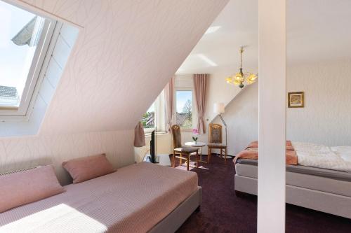 a bedroom with two beds in a attic at Ferienwohnung mit Charme in Peitz