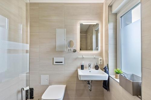 a bathroom with a sink and a mirror at Ferienhaus Heidi in Bad Düben