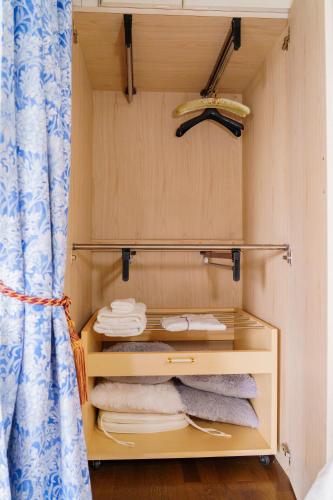 a small closet with towels and a curtain at Penthouse KOKO in Miyakonojō