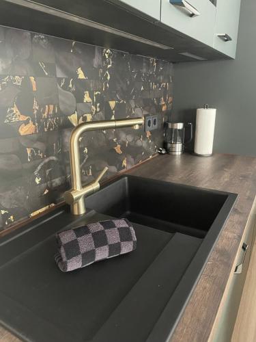 a kitchen counter with a sink with a towel on it at Design Apartment Flair u Komfort in Meschede