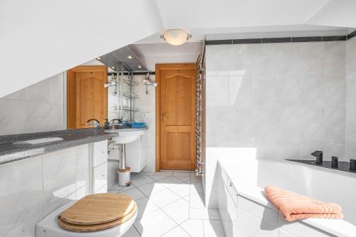 a bathroom with a toilet and a sink and a tub at Dachstübchen in Hagenburg