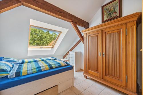a bedroom with a bed and a window at Dachstübchen in Hagenburg