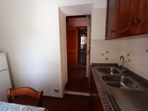 a kitchen with a sink and a counter top at Ester Home Procchio Mare E Sole in Marciana