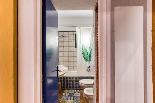 a bathroom with two toilets and a sink at Casa en urb Cala Montgó in L'Escala