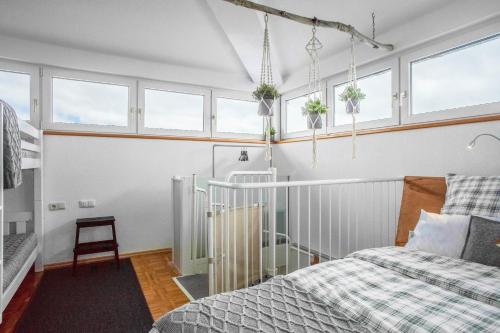 a bedroom with two beds and windows at Heimelig im Allgäu in Lindenberg im Allgäu