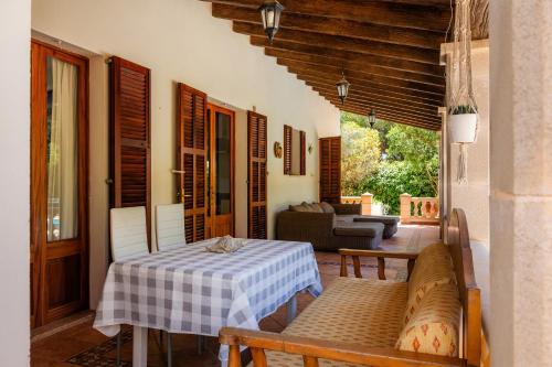 a living room with a table and a couch at Pomeres Nou in Sa Coma