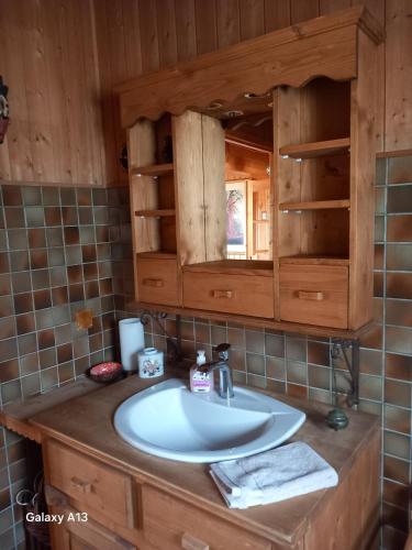 a bathroom with a sink and a mirror at Chalet Jura in Doucier