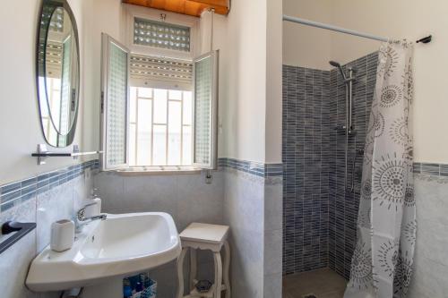 a bathroom with a sink and a shower at La casa di Ulisse 2 in Ispica