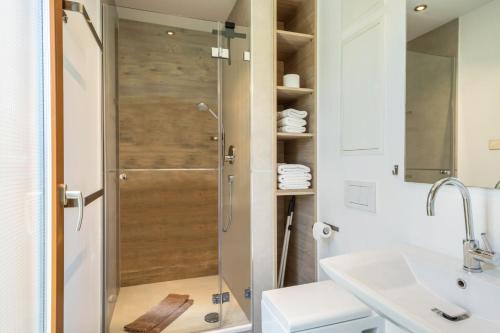 a bathroom with a shower with a glass door at Ferienhaus Im Tobel in Deggenhausertal
