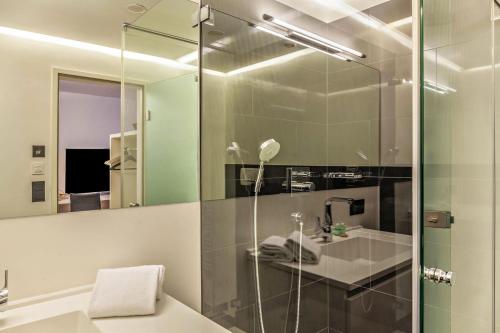 a bathroom with a shower and a sink and a mirror at Haus Excelsior Top 30 in Seefeld in Tirol