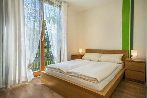 a bedroom with a bed and a large window at Ferienhaus Im Tobel in Deggenhausertal