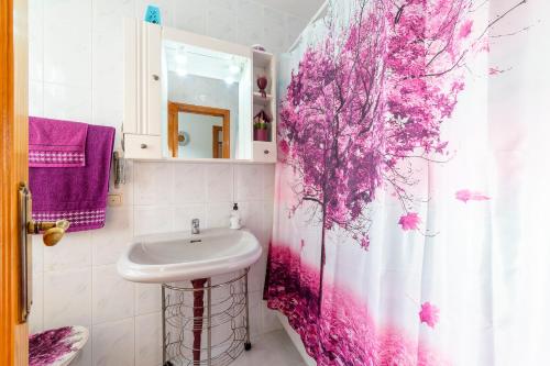 a bathroom with a sink and a pink tree shower curtain at Mccoy avenida 3 in Macael