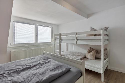 a bedroom with a bunk bed and a white bunk bed at Ferienwohnung am Blitzgi in Wehr