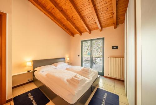 a bedroom with a bed and a large window at Central Penthouse Luino in Luino
