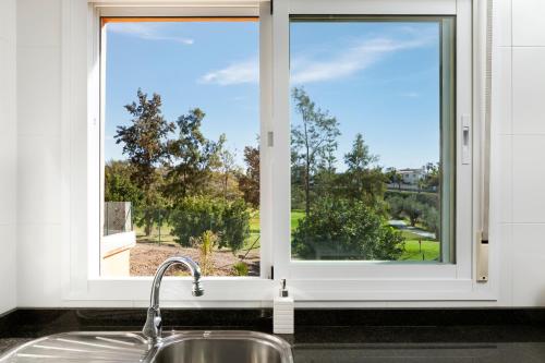 a kitchen sink and a window with a view at Apartamento Baviera Golf 002 in Vélez-Málaga