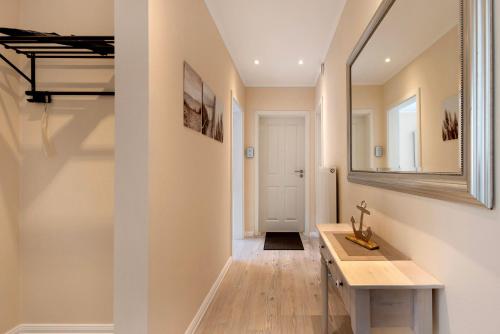 a bathroom with a sink and a mirror on the wall at Sabines Ferienwohnung 2 in Glückstadt